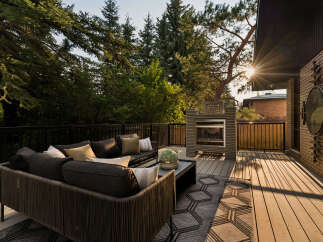 Experience outdoor living at its finest on this spacious deck, complete with a modern outdoor fireplace and comfortable seating.