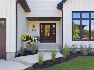 Modern farmhouse charm meets sophisticated design in this stunning home exterior.
