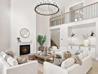 Experience luxury living in this stunning modern home featuring a grand, open-concept living area with a soaring ceiling and a magnificent circular chandelier.