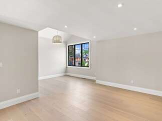 Experience modern living in this beautifully appointed room featuring a vaulted ceiling and a large window with a picturesque view.