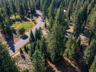 Nestled amidst a lush pine forest, this property offers a serene escape with a private golf course view.