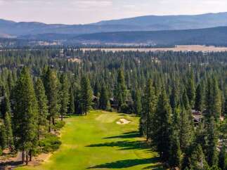 Experience luxury living nestled amidst a pristine pine forest, overlooking a beautifully manicured golf course.