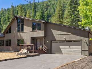 Nestled amidst a serene forest, this charming home offers a perfect blend of rustic appeal and modern comfort.