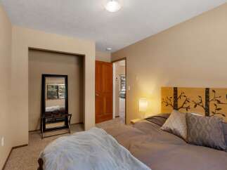 This charming bedroom features a cozy queen-size bed with a unique tree-branch headboard, perfect for a restful night's sleep.
