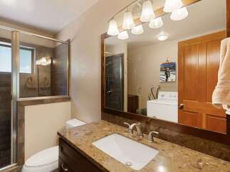This bathroom features a spacious walk-in shower with modern tile work and a glass enclosure.