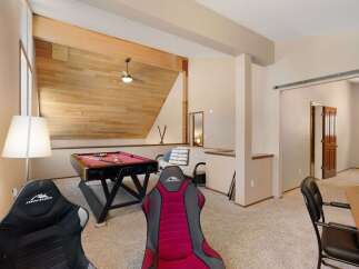 This versatile game room features a full-size pool table, perfect for friendly competitions.