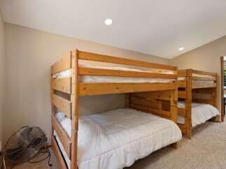 This spacious room features two sets of sturdy wooden bunk beds, perfect for accommodating multiple guests or a large family.
