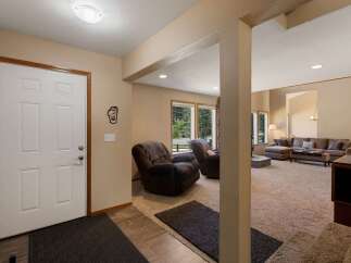 Step into a welcoming entryway that opens to a spacious living area, perfect for relaxation and entertaining.