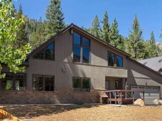 Nestled amongst towering pine trees and majestic mountains, this stunning home offers a serene retreat.