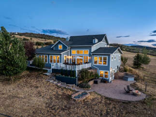 Experience luxury living in this stunning home, featuring a spacious deck perfect for entertaining and a beautiful stone patio with a fire pit for cozy evenings.