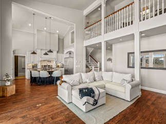 Experience luxury living in this stunning open-concept home, featuring a gourmet kitchen with a large island and bar seating, perfect for entertaining.