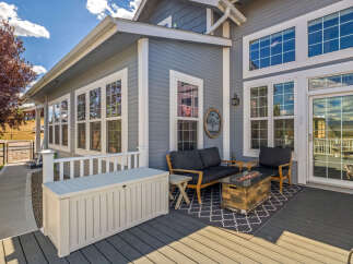 Enjoy outdoor living on this spacious deck featuring a cozy seating area with a fire pit, perfect for cool evenings.