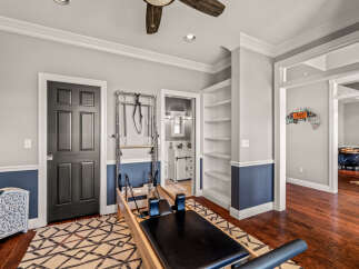 This home features a dedicated Pilates studio, complete with a reformer and Cadillac apparatus, perfect for your fitness routine.