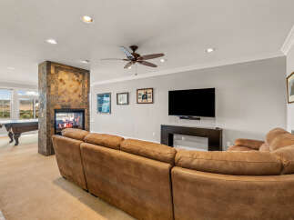 Experience ultimate relaxation in this spacious living area, featuring a cozy sectional sofa perfect for gathering with loved ones.