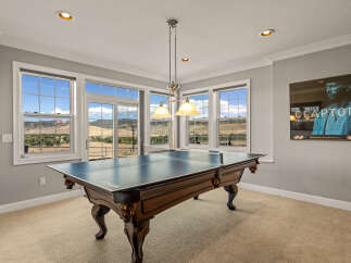 Enjoy endless entertainment in this versatile game room, featuring a premium ping pong table perfect for friendly competitions.
