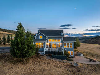 Experience luxurious living in this stunning home nestled in a serene, hilly landscape.