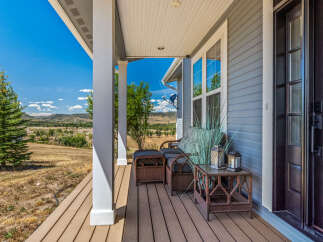 Enjoy breathtaking mountain views from this charming covered porch, perfect for relaxing or entertaining.