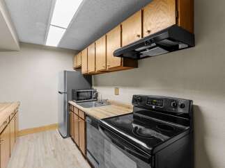 Discover this charming kitchen featuring a sleek black electric range with a smooth glass cooktop and a digital display.