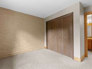 Discover this charming room featuring a textured tan brick accent wall, perfect for adding character and warmth.