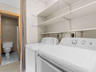 This laundry room features a stacked washer and dryer set, perfect for saving space.