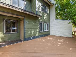 Step onto the spacious wooden deck of this charming home, perfect for outdoor relaxation and entertaining.