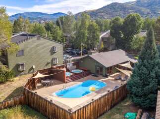 Enjoy resort-style living with this stunning property featuring a sparkling blue swimming pool and a relaxing hot tub, perfect for unwinding.
