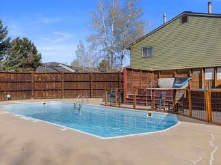 Enjoy a refreshing dip in this sparkling blue swimming pool, perfect for relaxation and recreation.