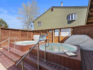 Relax and unwind in this inviting outdoor hot tub area, perfect for soaking up the sun or enjoying a starlit evening.