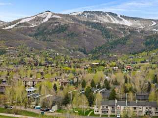 Discover this charming mountain community nestled against a backdrop of snow-capped peaks and lush green forests.
