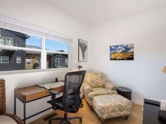 This home office features a spacious desk with a computer setup, perfect for remote work or study.