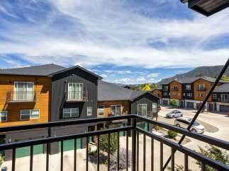 Discover modern living in this stunning townhome community, featuring contemporary architecture with wood and dark siding accents.