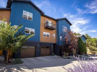 Discover modern living in this stunning multi-level townhouse featuring a striking blue and wood exterior.