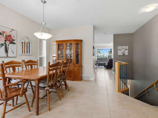 This dining room features a beautiful wooden dining set with chairs and a hutch, perfect for family meals and entertaining.