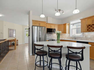 This spacious kitchen boasts a large island with seating, perfect for casual dining and entertaining.