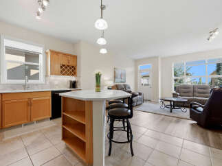 This open-concept living space seamlessly blends a modern kitchen with a comfortable living area.