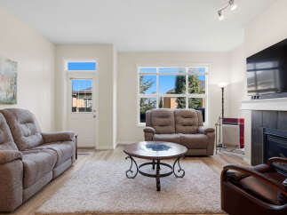 Step into this inviting living room, featuring comfortable seating arrangements perfect for relaxation and entertainment.