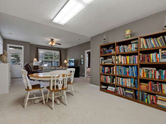 Discover a versatile living space featuring a cozy dining area with a round table and chairs, perfect for intimate meals.