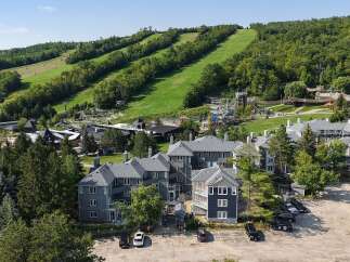 Discover this stunning multi-unit property nestled at the base of a scenic ski hill, offering breathtaking views and year-round recreational opportunities.