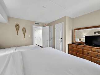 This charming bedroom features two comfortable beds, perfect for accommodating family or guests.