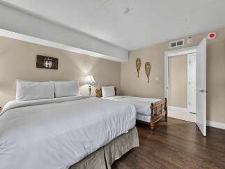 This inviting bedroom features a spacious king-size bed and a twin bed, perfect for families or accommodating guests.