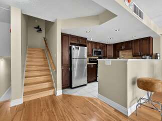 Discover this charming kitchen featuring rich espresso cabinetry and sleek stainless steel appliances, perfect for any home chef.