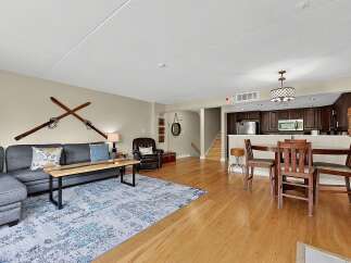 Experience comfortable living in this inviting open-concept space, featuring a cozy sectional sofa and a stylish coffee table perfect for gatherings.
