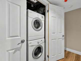 Discover convenient in-suite laundry with this stacked washer and dryer unit, perfect for maximizing space.