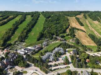 Experience the ultimate mountain getaway with this stunning aerial view of a resort-style property.
