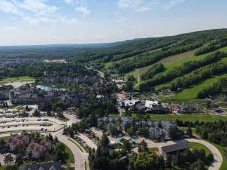 Discover this stunning mountain resort offering a luxurious village experience with a beautiful lake and charming architecture.