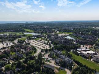 Discover this stunning aerial view of a picturesque resort community, showcasing a blend of luxurious residential properties and vibrant recreational facilities.