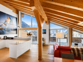 Experience luxury mountain living in this stunning open-concept loft featuring a modern kitchen with a large island and breathtaking panoramic mountain views.