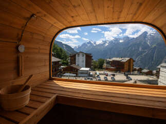 Experience ultimate relaxation with this stunning sauna offering panoramic views of the majestic Alps.
