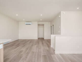Experience modern living in this spacious, open-concept home featuring sleek hardwood floors and a neutral color palette.