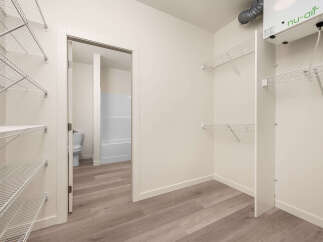 Discover ample storage with this spacious walk-in closet, featuring extensive wire shelving on multiple walls.